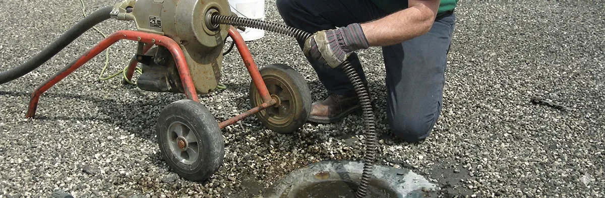 sewer rodding technician actively removing blockages from a sewer line in Boca Raton, FL